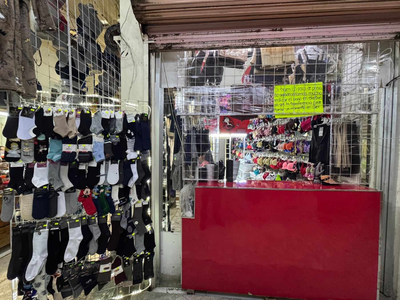 Frente del puesto con calcetines colgados y mostrador rojo